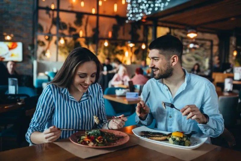 romantic couple in restaurant having lunch