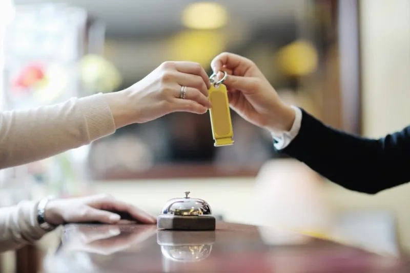 business woman at the reception of a hotel checking in
