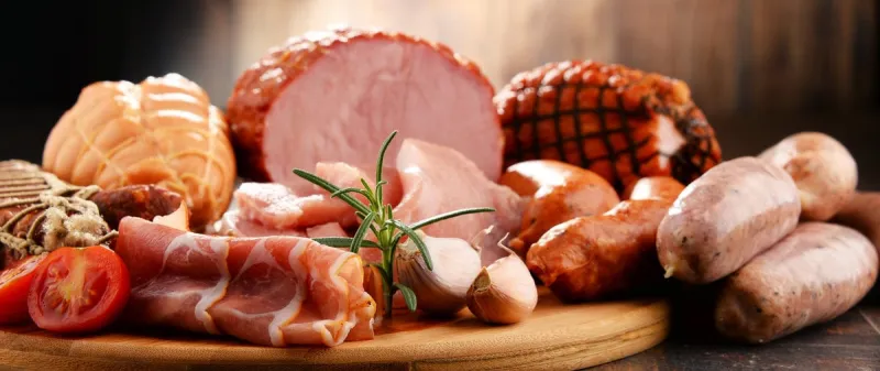 assorted meat products including ham and sausages