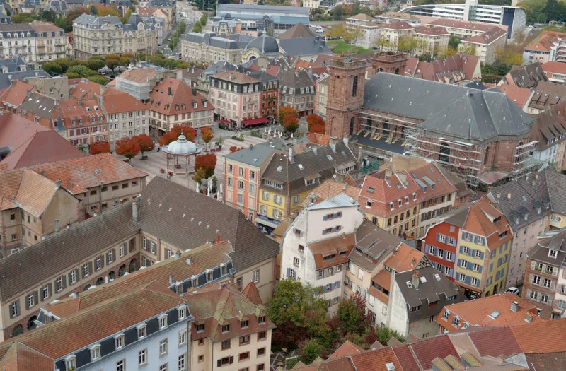 rooftops of the old city of belfort aerial view of the historic houses and buildings arranged densely to each other view from the citadel or fortress surrounding the city