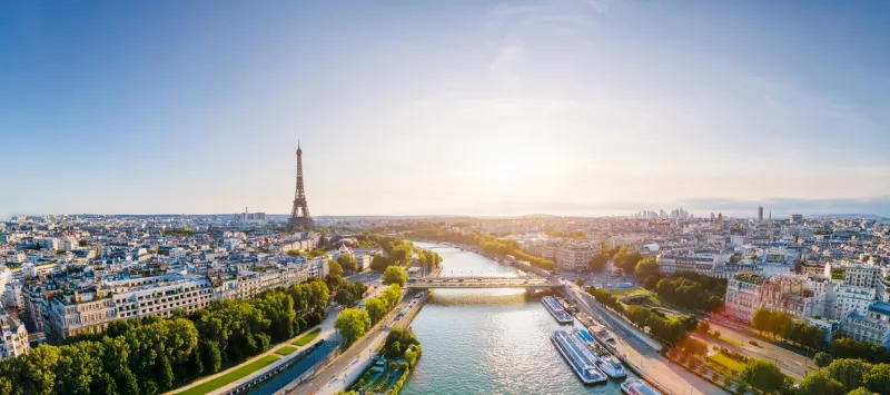 paris aerial panorama with river seine and eiffel tower, france romantic summer holidays vacation destination panoramic view above historical parisian buildings and landmarks with blue sky and sun
