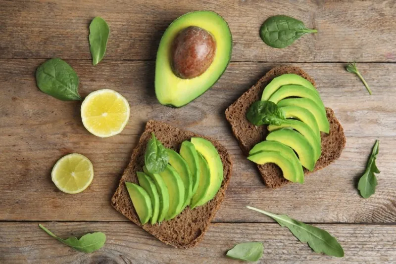 flat lay composition with avocado toasts on wooden table