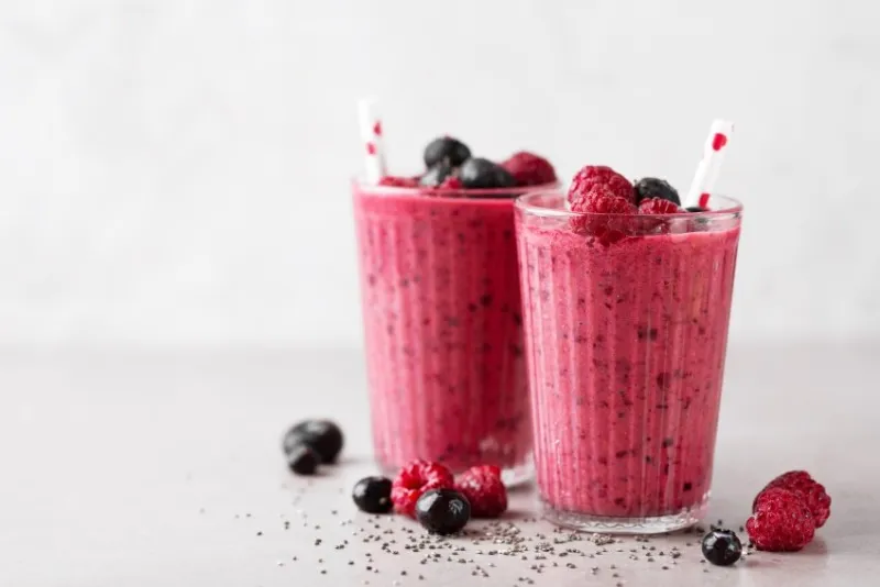 tasty healthy dieting red berry smoothie with chia seeds in glasses on grey background closeup with copy space