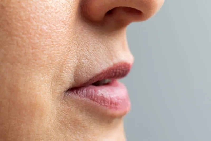 close up macro detail of wrinkles around mouth and lips of middle aged woman