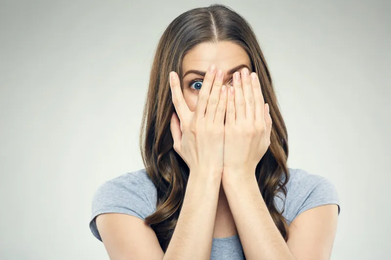 close up face woman portrait with fear emotion isolated in studio