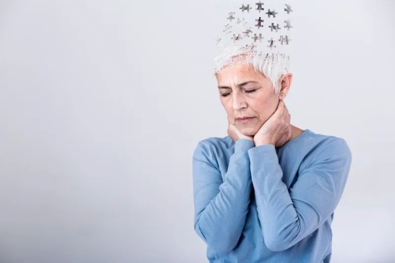 memory loss due to dementia senior woman losing parts of head as symbol of decreased mind function senior woman losing parts of head feeling confused as symbol of decreased mind function