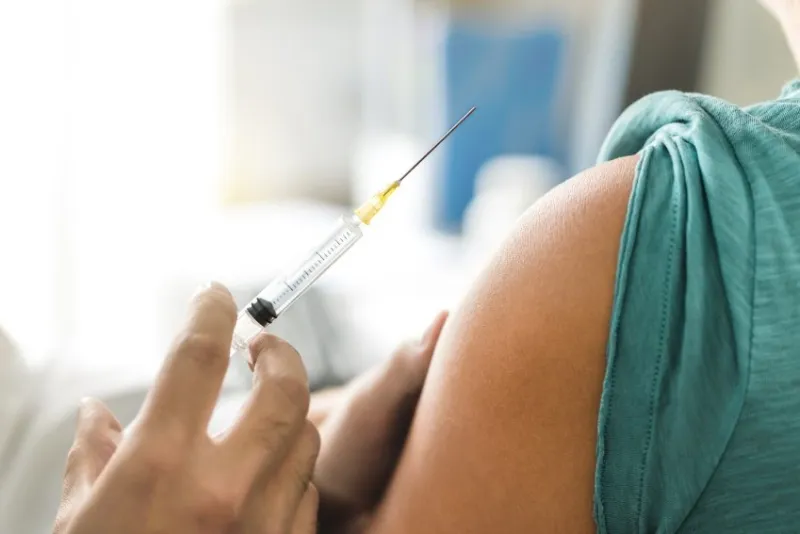 vaccine or flu shot in injection needle doctor working with patient's arm physician or nurse giving vaccination and immunity to virus, influenza or hpv with syringe appointment with medical expert