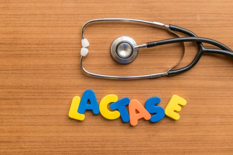 lactase colorful word with stethoscope on wooden background