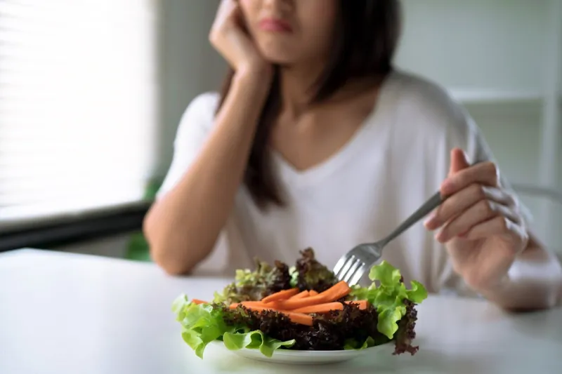unhappy women is on dieting time, girl do not want to eat vegetables