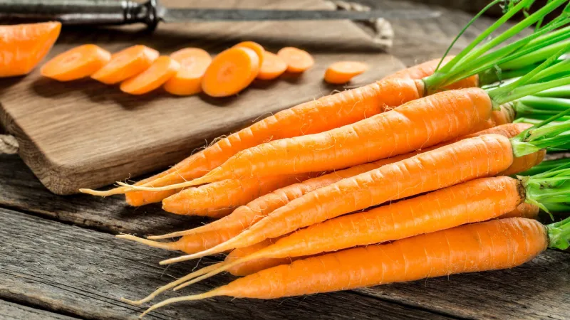 fresh and sweet carrot on a grey wooden table