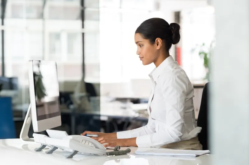 multi ethnic business woman working with computer at the office focused young businesswoman checking email with laptop office worker typing on a keyboard in her office