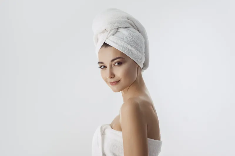 spa skin care beauty woman wearing hair towel after beauty treatment beautiful multiracial young woman with perfect skin isolated on white background mixed race caucasian asian looking at camera