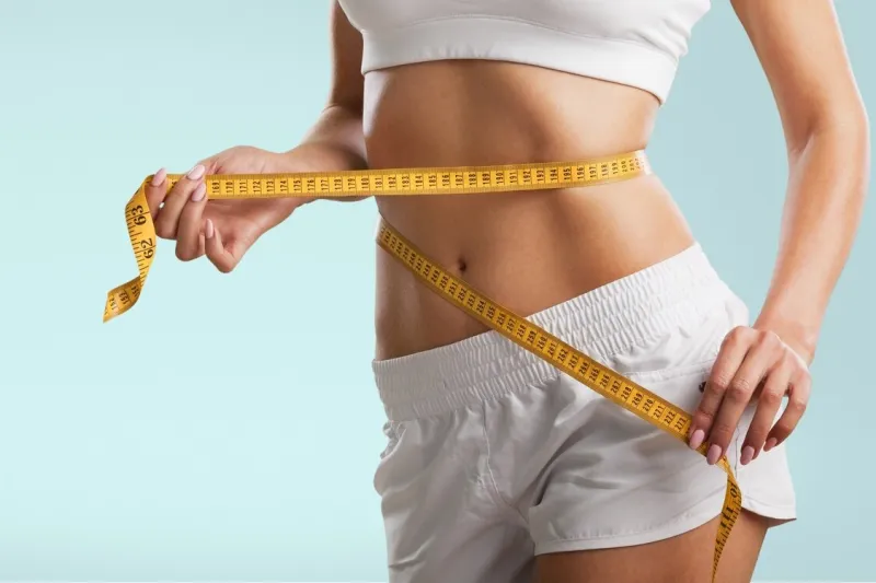 young woman showing waist weight loss concept