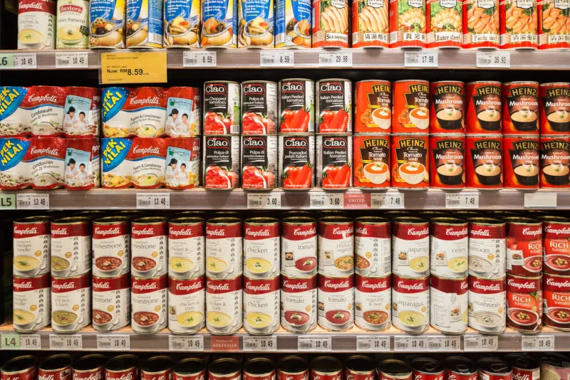 kuala lumpur, malaysia - december 22, 2017  canned soups, from cambell's or heinz among others, are displayed in a supermarket shelf in malaysia