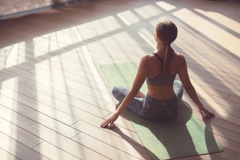 young girl doing yoga in the sunlight