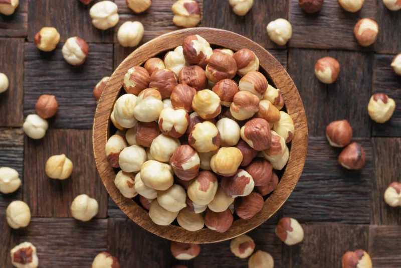 hazelnut peeled roasted in bowl on wooden table background