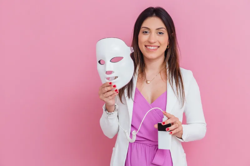 beautician, aesthetic doctor, beauty professional, led mask device, light therapy, color therapy with arms crossed