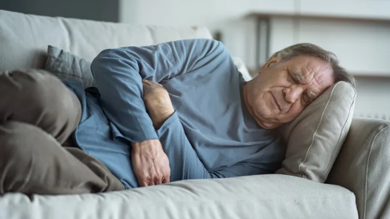 senior man with stomach pain