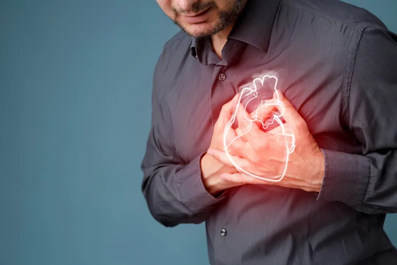 young man pressing on chest with painful expression severe heartache, having heart attack or painful cramps, heart disease