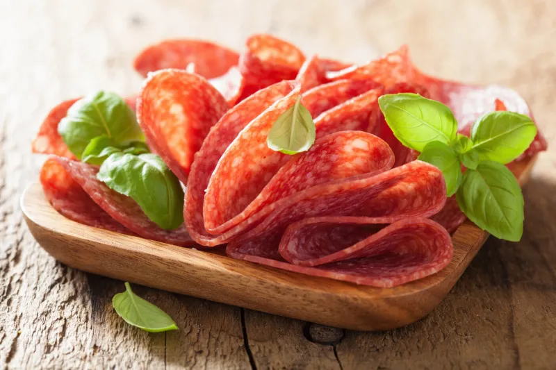 salami slices in wooden plate