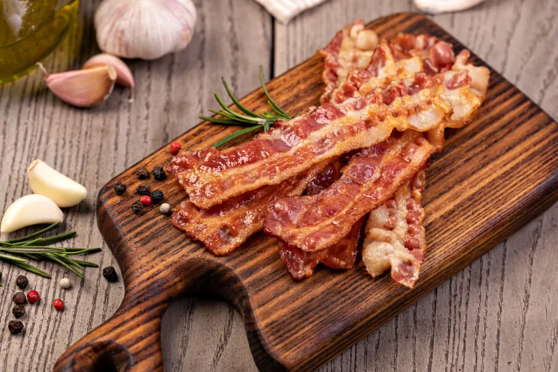closeup of slices of crispy hot fried bacon