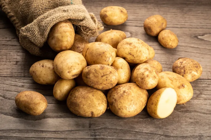 fresh new potatoes on wooden background solanum tuberosum