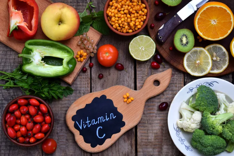 composition of products containing ascorbic acid, vitamin c - citrus, cauliflower, broccoli, sweet pepper, kiwi, dog rose, tomatoes, apple, currant, sea buckthorn top view flat lay healthy food
