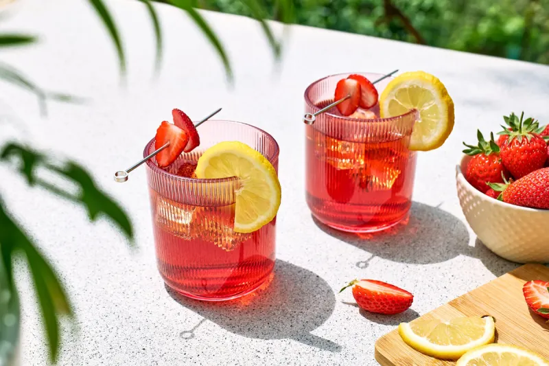 fresh summer strawberry cocktail or mocktail on the table in the garden sparkling pink strawberry lemonade