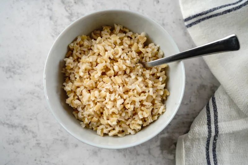 cooked brown rice served in a bowl, selective focus