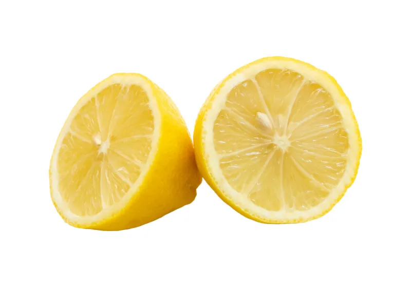 fresh juicy natural organic lemon fruit cut in half, round split organic natural yellow lemon two halves on the table side, object isolated on white background, cut out, nobody, circle shape closeup