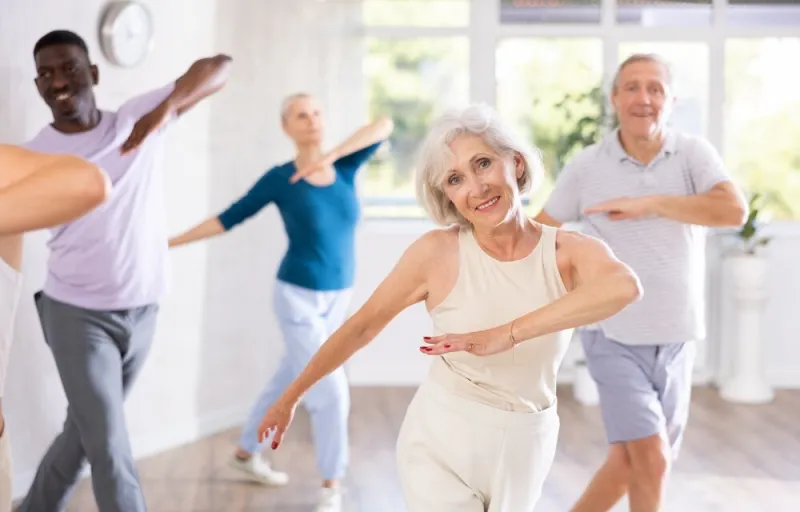 positive,sporty,senior,woman,participating,group,dance,class,,practicing,modern