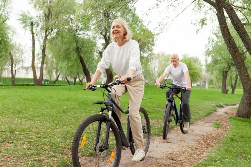 elderly,senior,couple,rides,bicycle,in,the,park,in,the