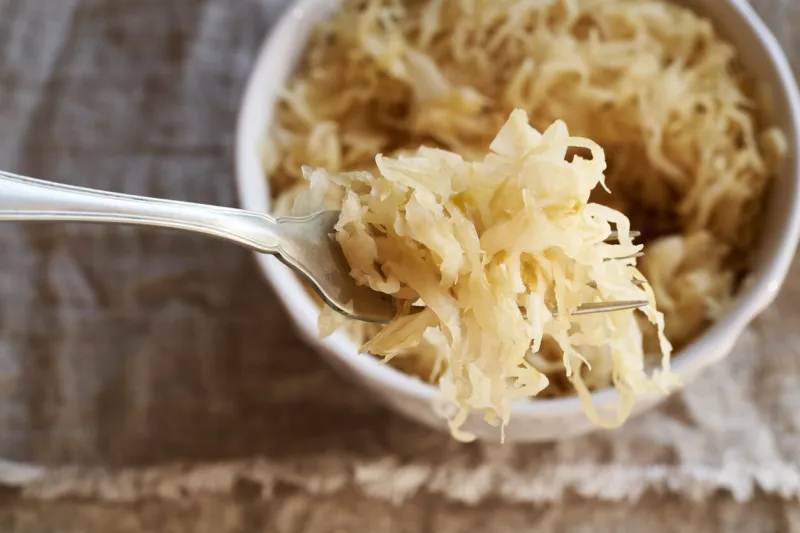 fermented cabbage or sauerkraut on a metal fork