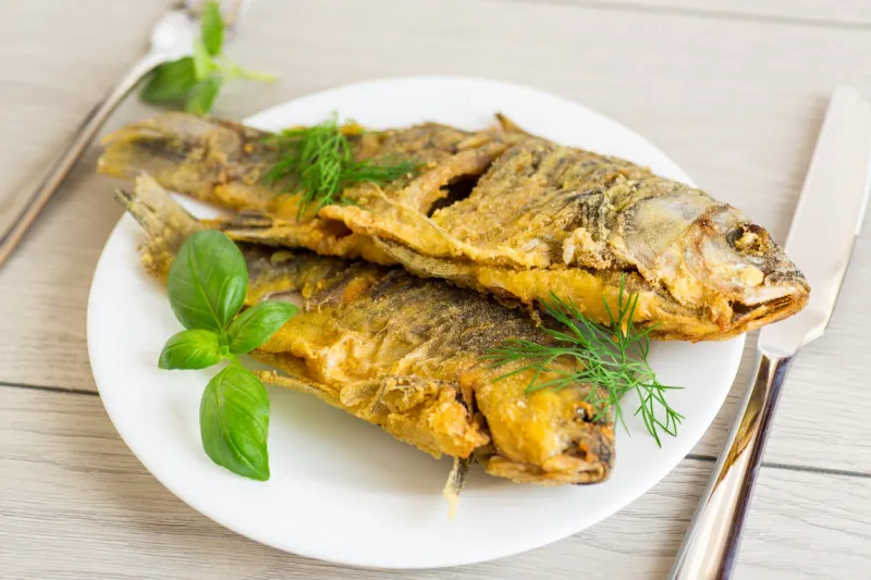 homemade dish - golden crucian carp on a plate with spices