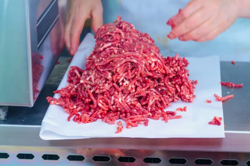 butcher prepares minced meat in the market butchery concept