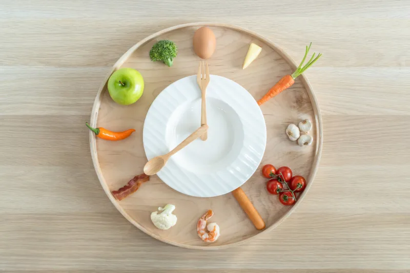 intermittent fasting diet concept with 8-hour clock timer for eating nutritional or keto low carb, high protien food meal healthy dish and 16-hour skipping meal for weight loss