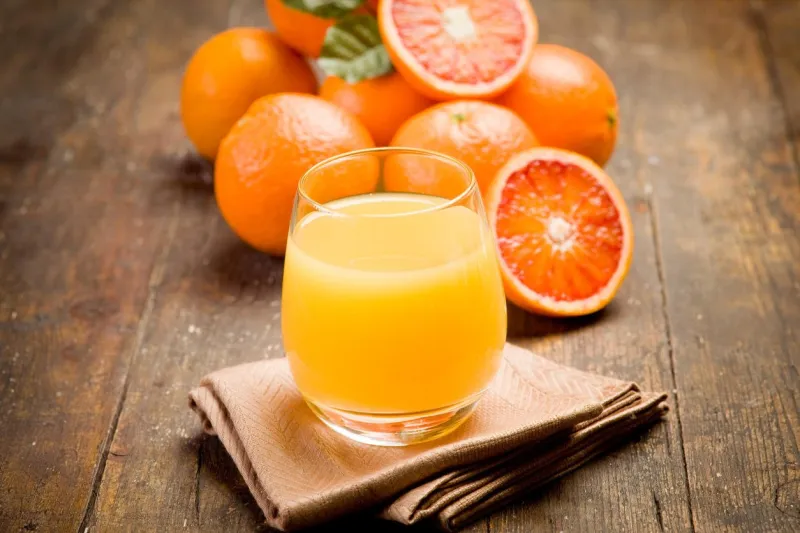 jus d'orange pressé frais sur une table en bois ancienne