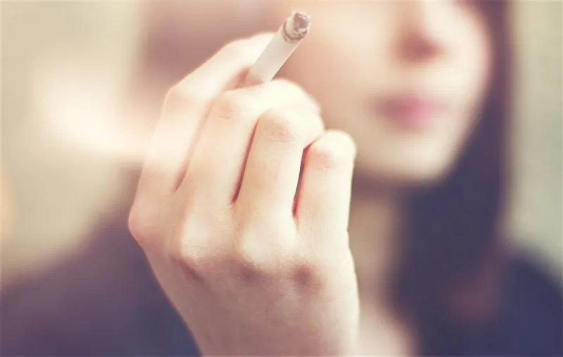 woman hands holding cigarette outdoor