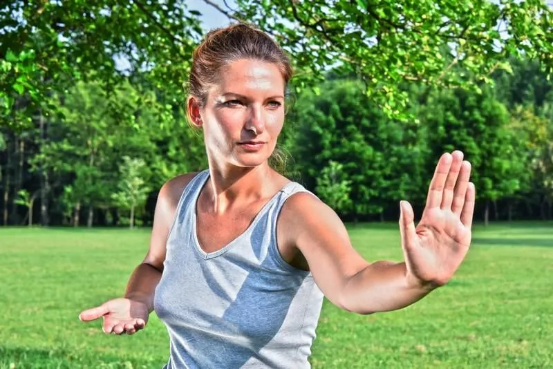 young woman during tai chi exercise in the park