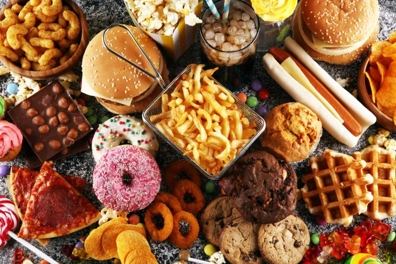 unhealthy products food bad for figure, skin, heart and teeth assortment of fast carbohydrates food with fries and cola