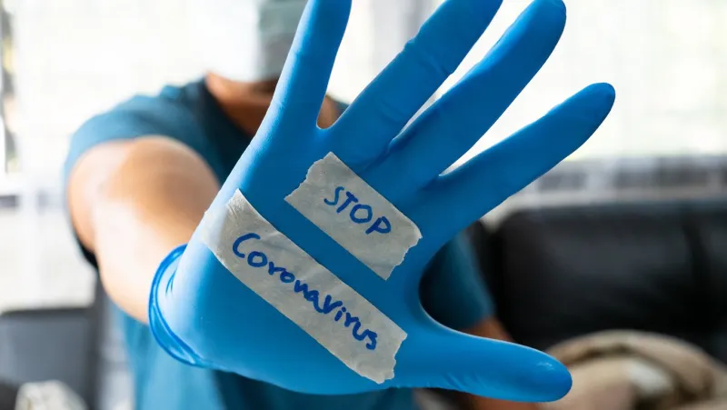 the glove-wearer has a message to stop the coronavirus