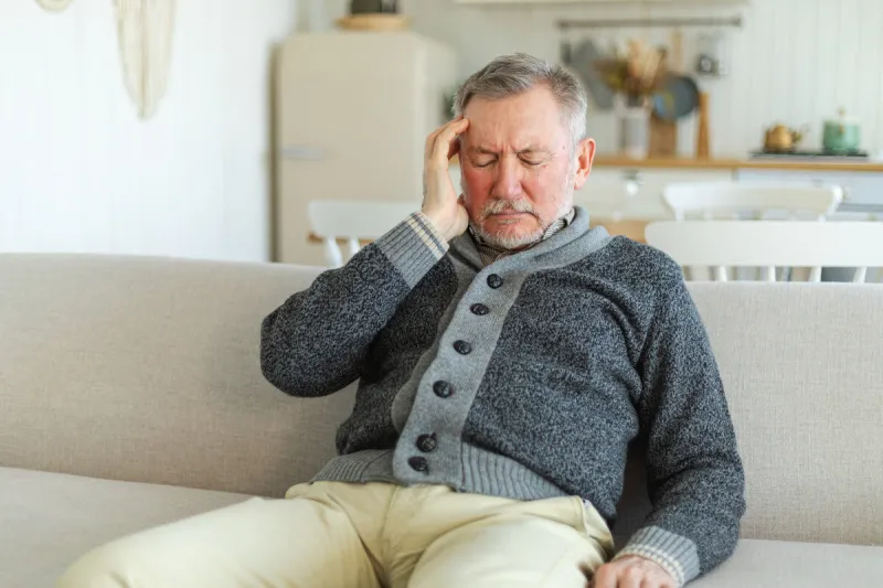 headache pain unhappy middle aged senior man suffering from headache sick rubbing temples at home mature old senior grandfather touching temples experiencing stress man feeling pain hurt in head