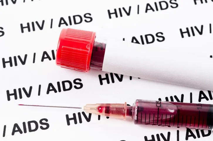 sample blood for hiv test in syringe on hiv aids background