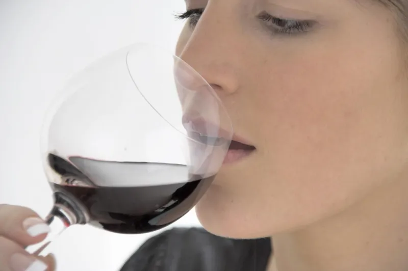 femme avec un verre de vin rouge