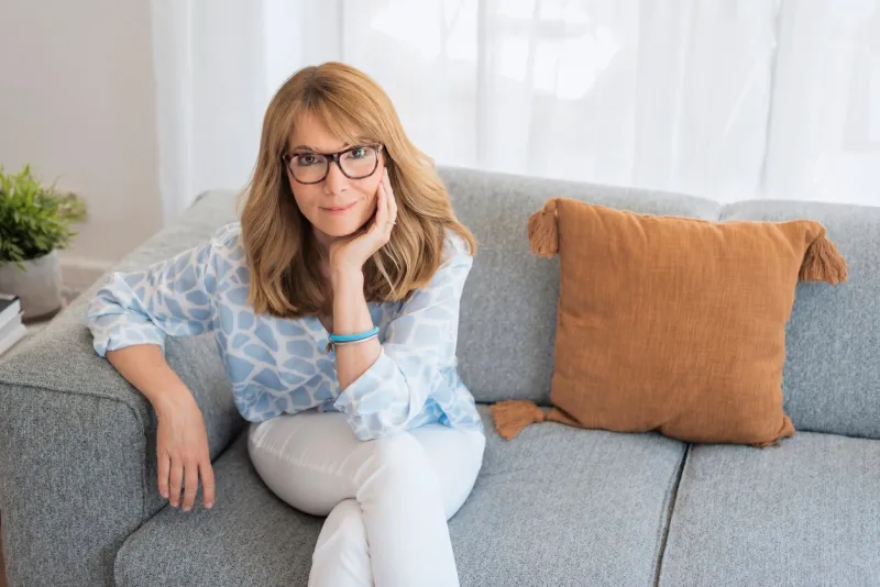confident middle aged woman portrait while relaxing at home