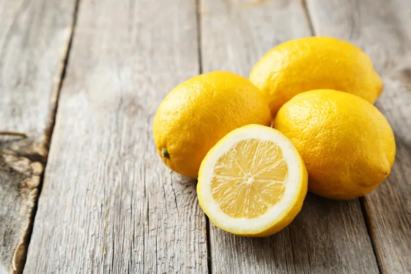 lemons on grey wooden background
