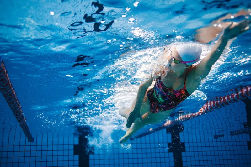 underwater shot of fit swimmer training in the pool female swimmer inside swimming pool
