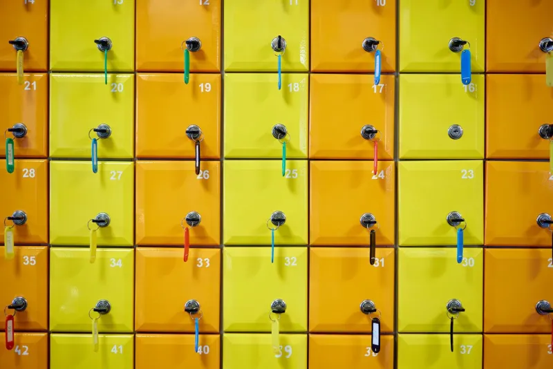 series of colored, numbered lockers with locks, keys and tags