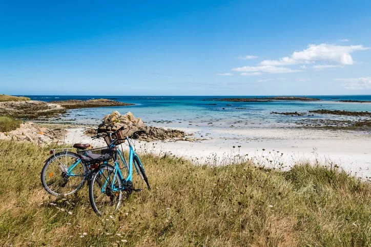 bicycles parked against the beach in the island of batz with no people summer adventure