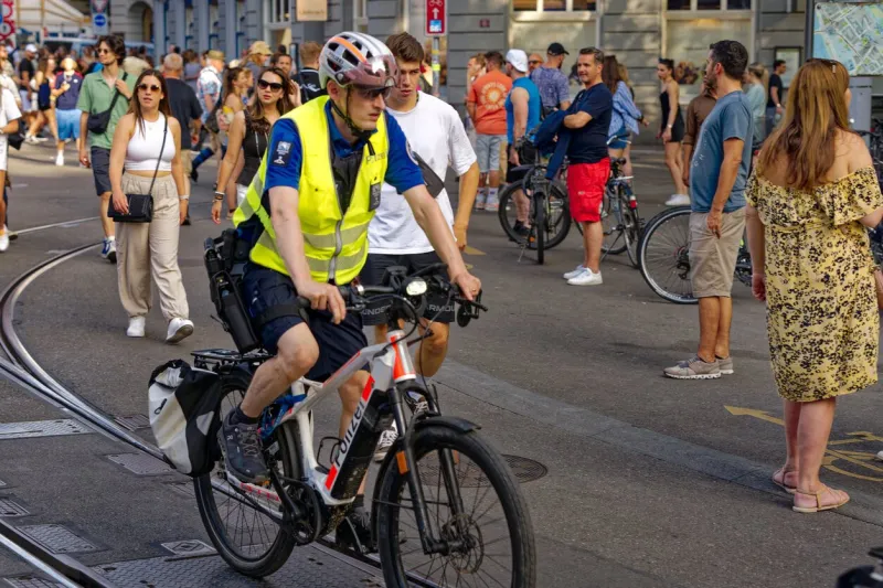 police squad on electric bicycles at fun fair named züri fäscht at city of zürich on a sunny summer evening photo taken july 7th, 2023, zurich, switzerland